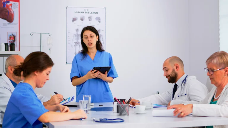 medical-people-meeting-planning-with-shareholders-hospital-office-sitting-desk-doctors-nurses-brainstorm-ideas-together-physicians-diagnosis-presentation-data-using-tablet